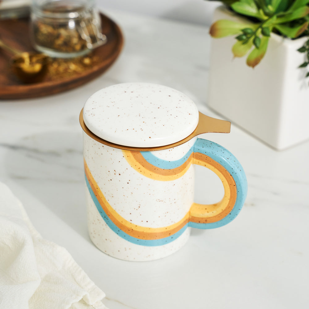 12 OZ CERAMIC MUG WITH LID AND GOLD INFUSER - This 12 oz. ceramic mug includes a built-in infuser basket and lid to keep your favorite tea piping hot. Easily brew delicious loose leaf tea in loose leaf tea mugs with infuser and lid. Hand wash.
