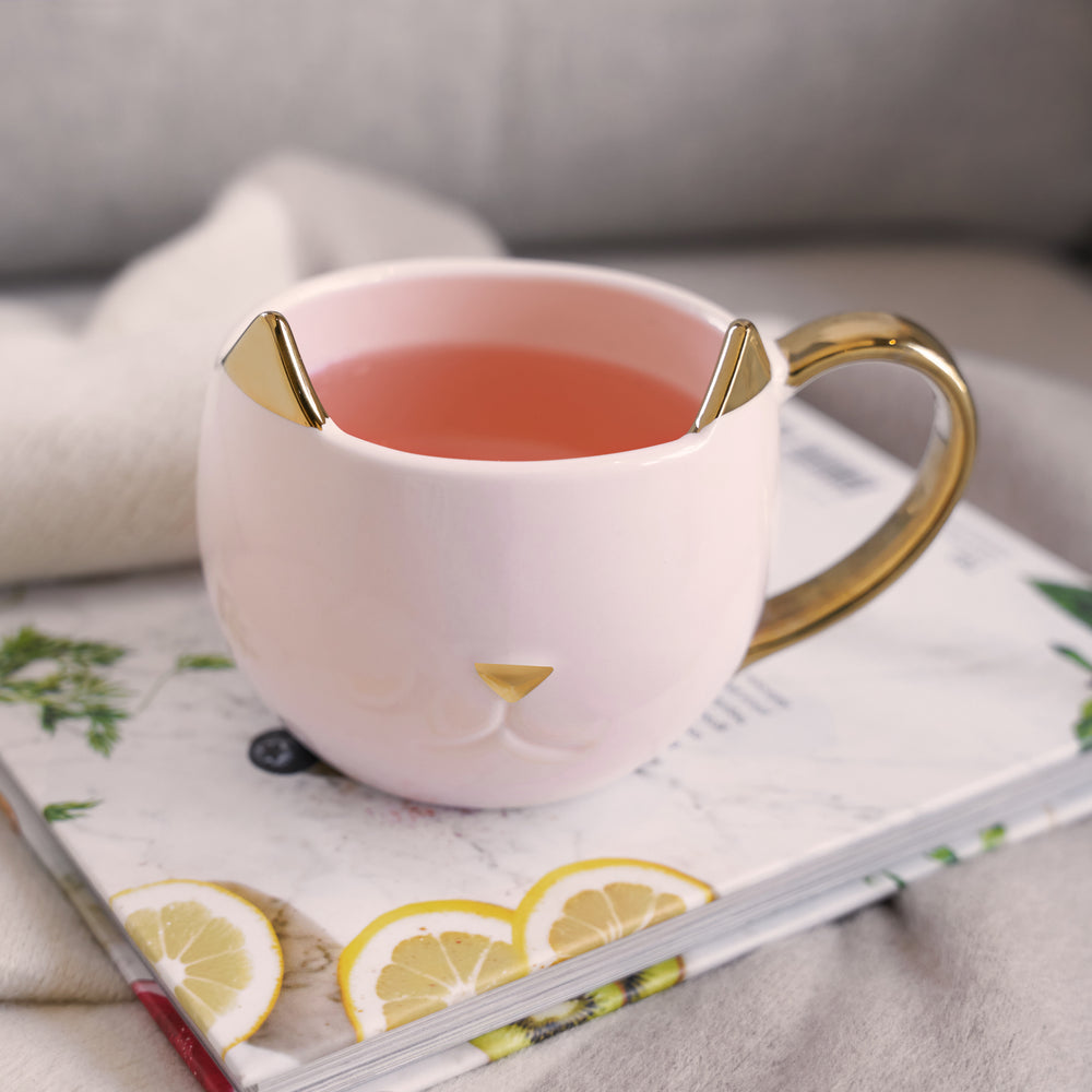 PINK KITTY MUG WITH METALLIC FINISH – Fun yet stylish, this cat ceramic coffee mug is made from a shiny pink ceramic with metallic gold detailing. This is a truly beautiful and charming catmug that's the perfect cat mom mug and brightens up your day.